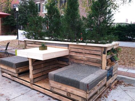 An Outdoor Seating Area Made Out Of Pallets And Wooden Crates With