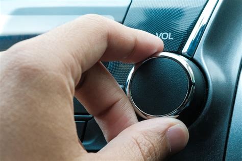 Premium Photo Cropped Hand Of Person Adjusting Volume In Car