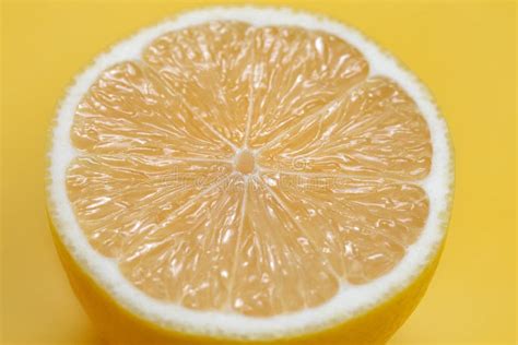 Macro Photo Of Lemon Fruit Slice On Yellow Background Stock Image