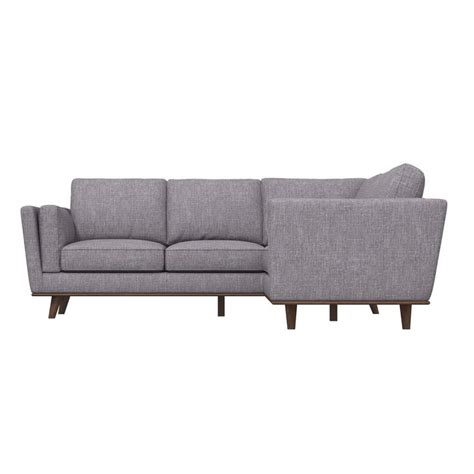 a gray sectional couch sitting on top of a white floor