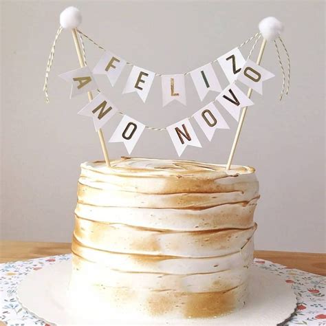 A Cake With White Frosting Sitting On Top Of A Table