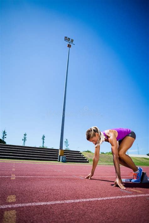 Atleta De Sexo Femenino Listo Para Correr En Pista Corriente Foto De