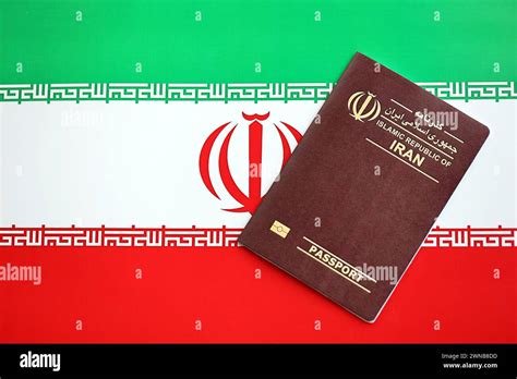 Red Islamic Republic Of Iran Passport On National Flag Background Close Up Tourism And