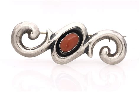 Lot - FRANCES JONES NAVAJO STERLING SILVER CORAL BROOCH
