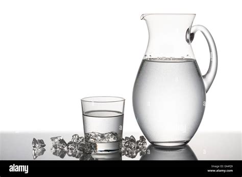 Jug And Glass Full Of Water With Pieces Of Ice Cubes Stock Photo Alamy