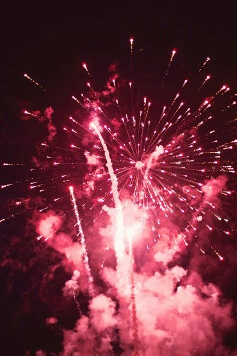 Bright firework with smoke cloud in dark sky at night · Free Stock Photo