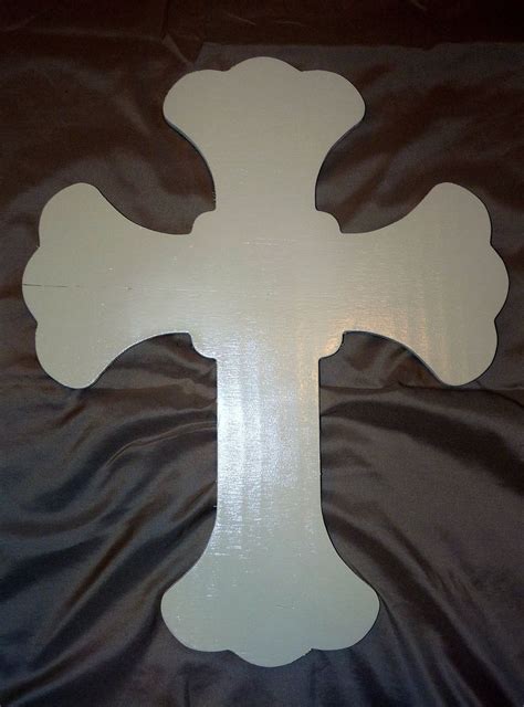 A Large Wooden Cross Sitting On Top Of A Bed