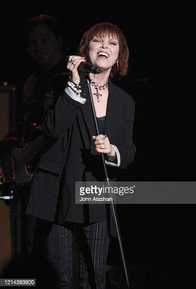 Singer Pat Benatar is shown performing on stage during a live concert ...