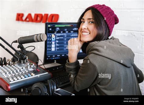 Beautiful Happy Young Female Radio Host Broadcasting In Studio Using