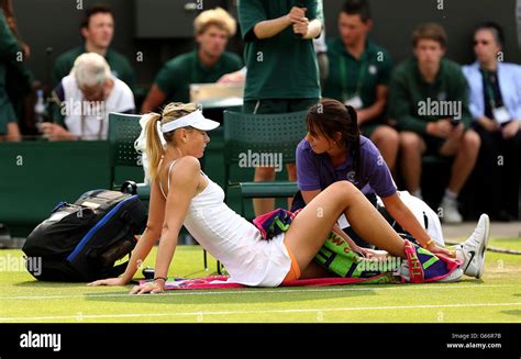 Russia's Maria Sharapova is treated for an injury during her match against Portugal's Michelle ...