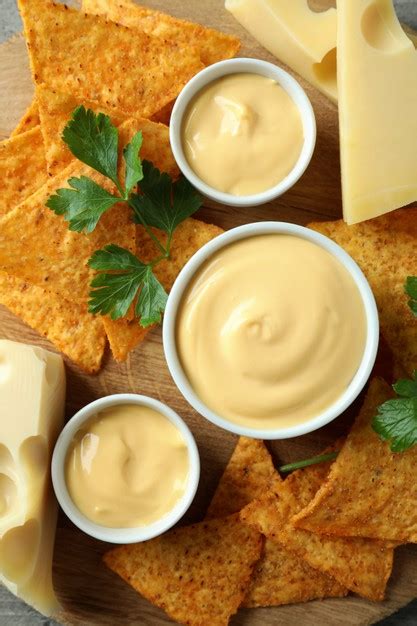 Premium Photo | Concept of snack with chips and cheese sauce, top view