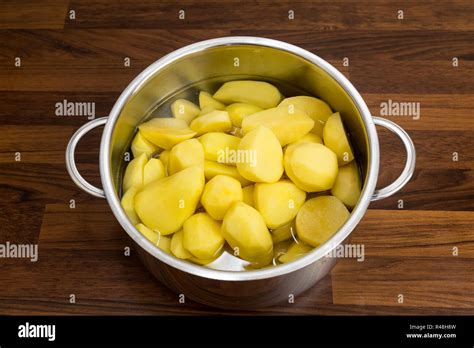 In A Saucepan Silver Fresh Peeled Potatoes In The Water So The