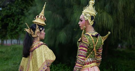 Portrait of Thai woman and man in traditional dress looking at camera ...