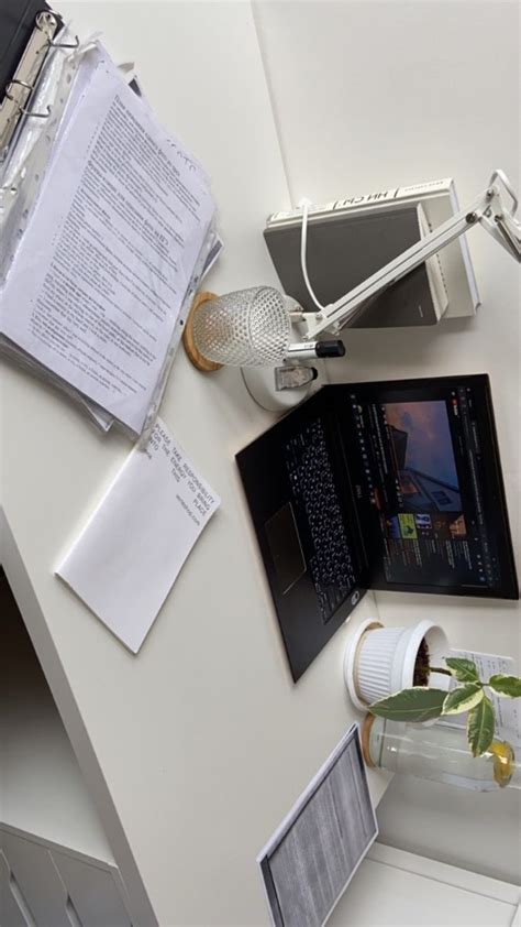 An Overhead View Of A Desk With Papers And Laptop