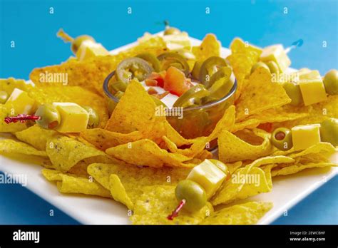 Tray of nacho chips with jalapenos and dipping sauce Stock Photo - Alamy