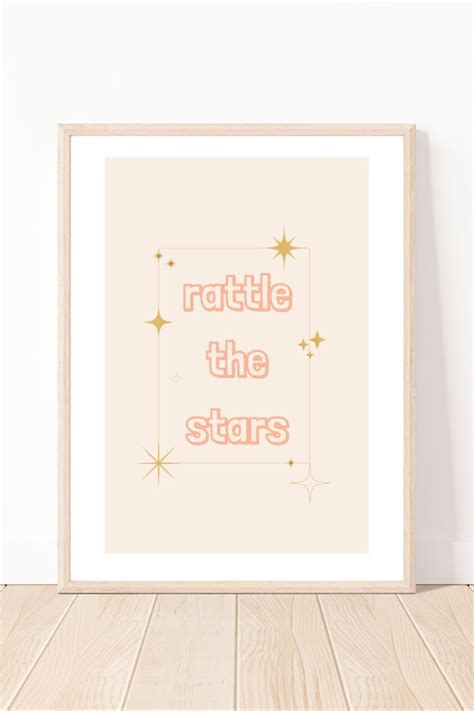 A Framed Print With The Words Rattle The Stars On It In Pink And Gold Foil