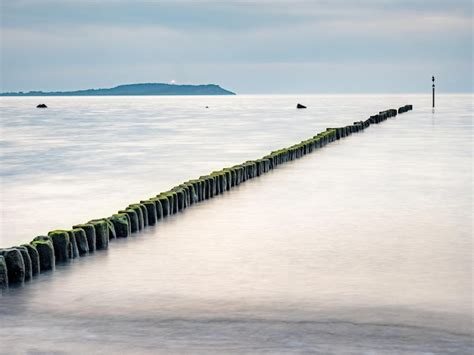 Premium Photo Hiddensee Island With Lighthouse And Breakwater Poles