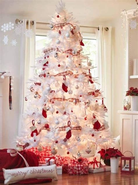 A White Christmas Tree Decorated With Red And Silver Ornaments