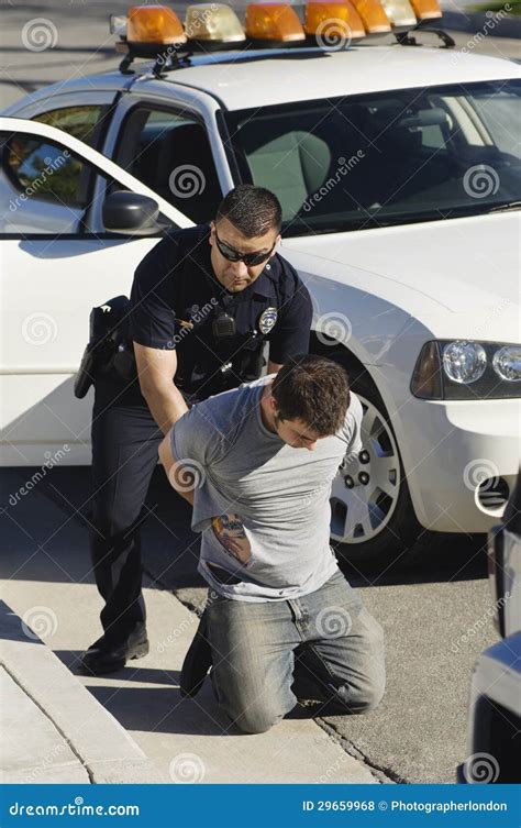 Police Officer Arresting Young Man Stock Photo Image Of Outdoors