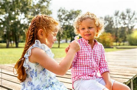 Kids Couple In The Park With Lollipops By Stocksy Contributor Marco