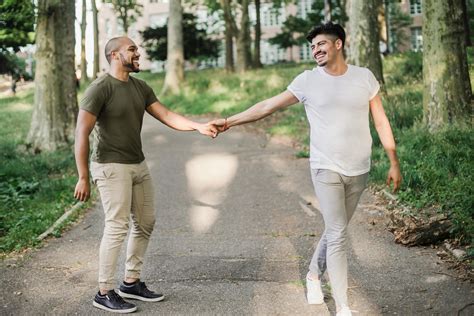 Two Men Holding Hands and Walking Together · Free Stock Photo