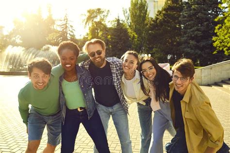 Cheerful Positive Young Friends Posing For A Group Photo In A Summer