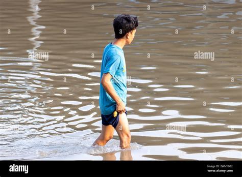 SAMUT PRAKAN THAILAND FEB 11 2024 A Man Wades Through A Flooded