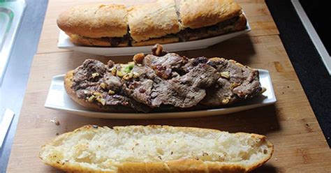 Three Plates Filled With Meat And Bread On Top Of A Wooden Table Next