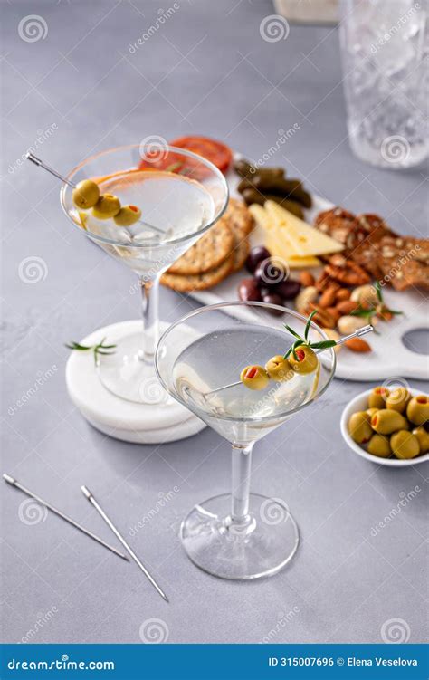 Traditional Martini Cocktail With Olive Garnish And Charcuterie Board