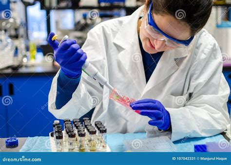 Woman Scientist Performing Biomedical Research In Laboratory Stock