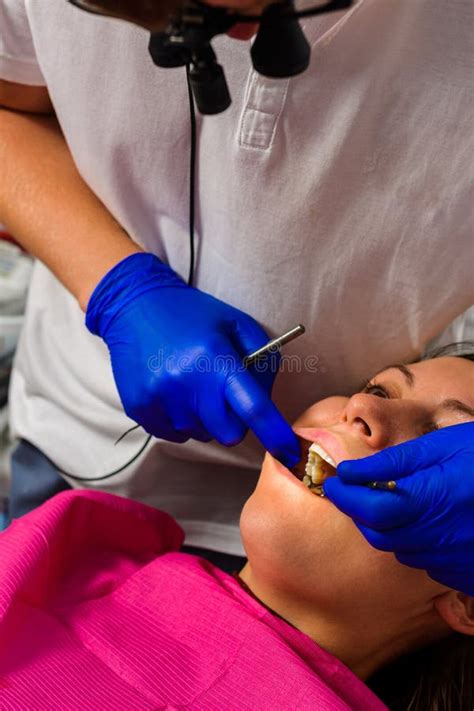 The Dentist Examines The Oral Cavity Before Treating The Problem Areas