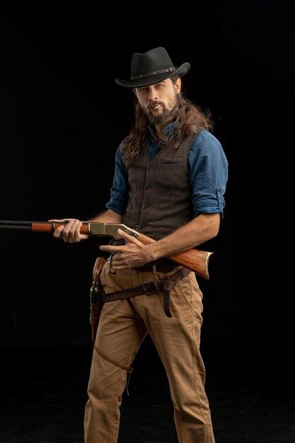 Premium Photo Midsection Of Man Holding Hat Against Black Background