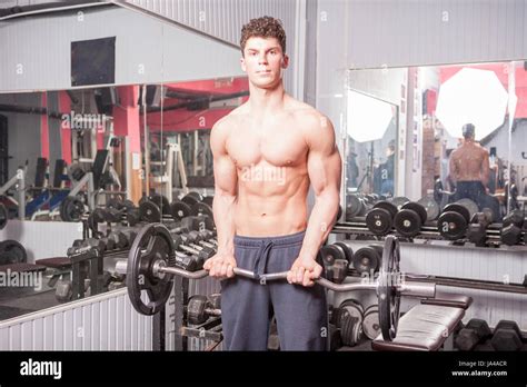 Strong Muscular Guy In The Gym Lifting Heavy Weights Bodybuilder