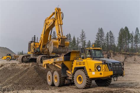 A Komatsu PC1250 Excavator Loads Ore Into A Komatsu HM400 Dump Truck