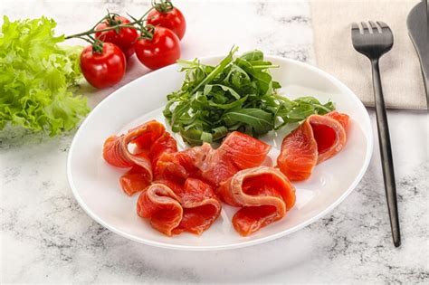 Premium Photo Sliced Salmon With Fresh Arugula