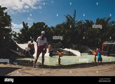 Female lifeguard standing near kids swimming pool Stock Photo - Alamy