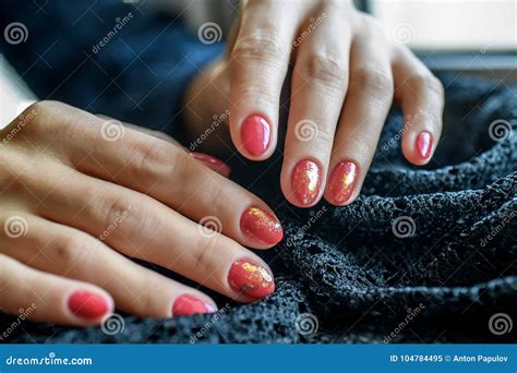 Woman With Beautiful Manicured Red Fingernails Gracefully Crossing Her