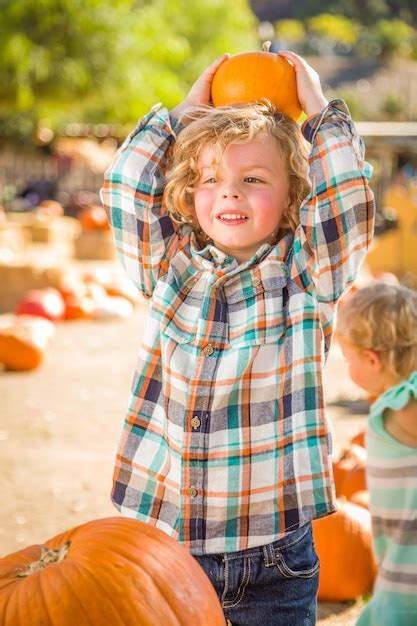 Premium Photo Little Boy Standing In A Rustic Ranch Setting At The