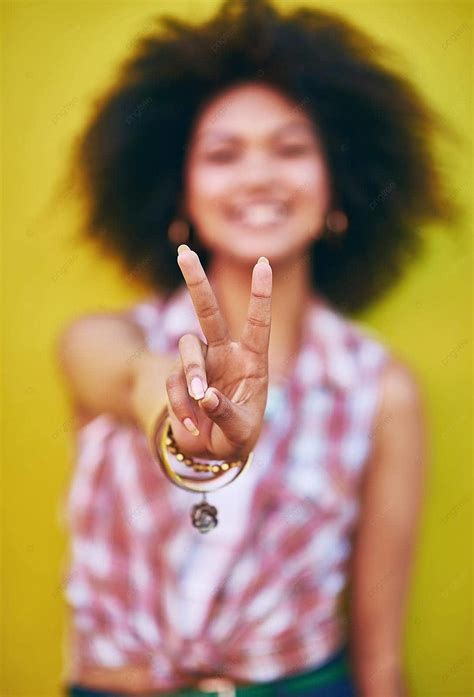 Fashion Statement Of Peace Young Woman Flashing Peace Sign Photo