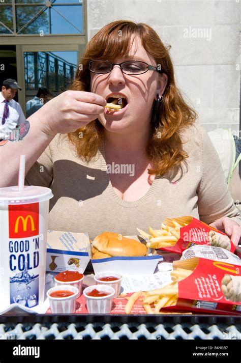 Overweight Woman Eating McDonald S Fast Food Meal Stock Photo Alamy