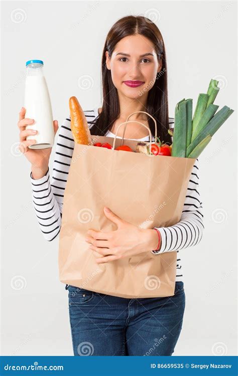 Portrait Of Beautiful Smiling Woman Holding Shopping Paper Bag With