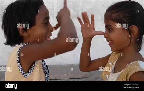 Closeup Of Two Cute Little Girls Mocking Each Other India Stock Photo