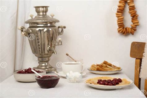 Vintage Samovar Cup Of Hot Drink And Snacks Served On Table Indoors