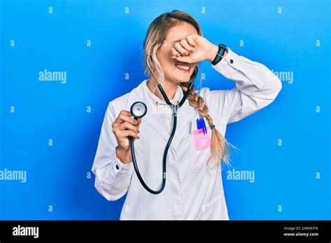 Beautiful Young Blonde Doctor Woman Holding Stethoscope Smiling