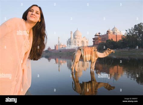 Woman With A Camel And A Mausoleum In The Background Taj Mahal Yamuna