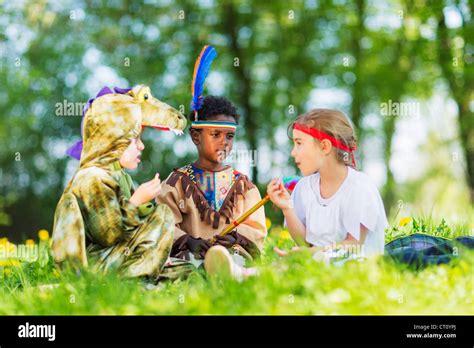 Boys playing dress up outdoors Stock Photo - Alamy