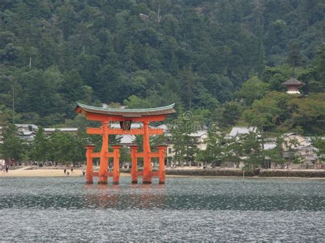 A Traditional Japanese Gate Of Itsukushima Shrine Floating In The Water