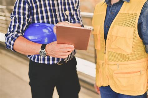 Premium Photo Midsection Of Engineers Working In Factory