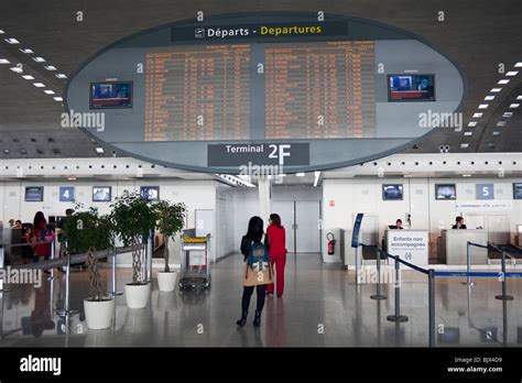 Passengers Looking At Departure Announcement Board Terminal 2 Charles