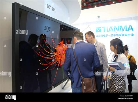 --FILE--Visitors look at 110-inch 8K ultra-high-definition (UHD) LCD ...